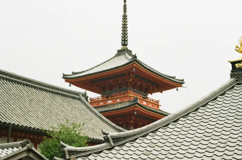 A red pagoda above traditional tiled rooftops