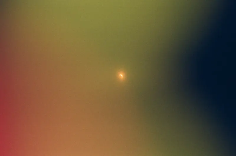An abstract wash of green and amber light on film